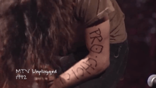 Pearl Jam's Eddie Vedder writes "Pro Choice" on his arm during their MTV Unplugged performance